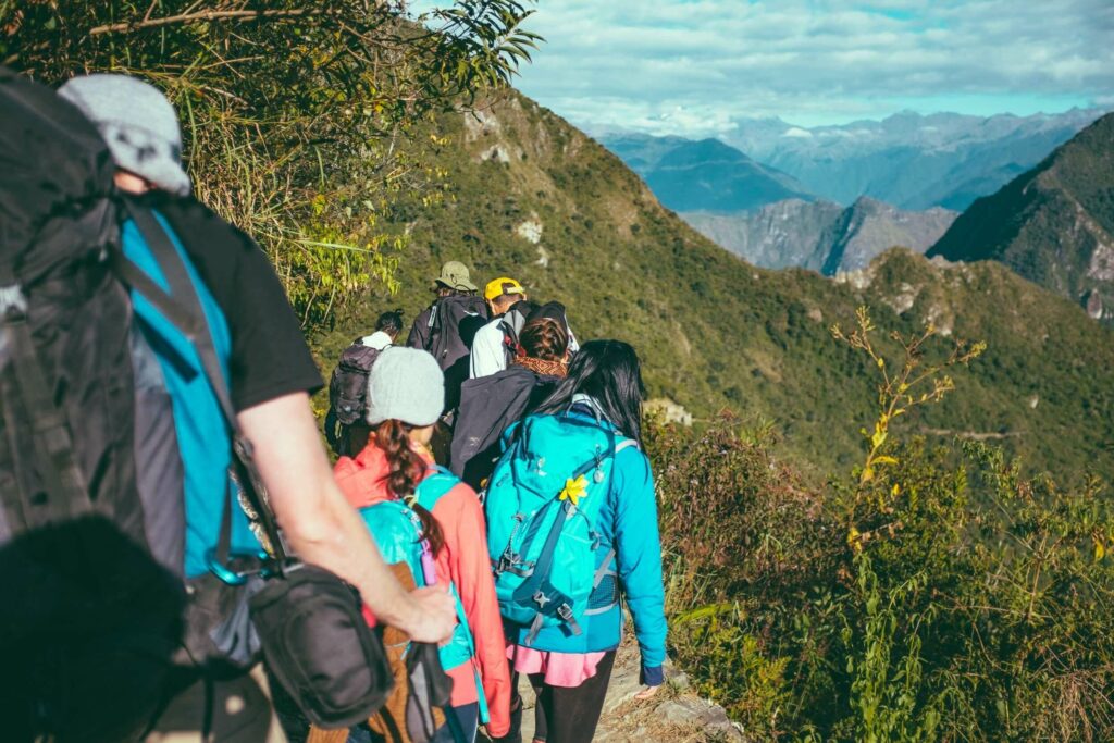 Alida Miranda-Wolff, The Secret to Leading Successful Teams: Small, Daily Actions article, feature image, group of men and women hiking with a mountain view