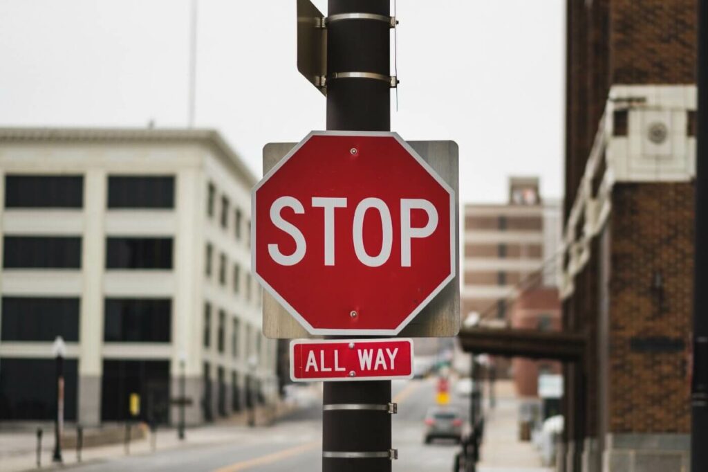 alida miranda-wolff, How Cultish Language Shuts Down Conversation in DEIB article image, stop sign in middle of city